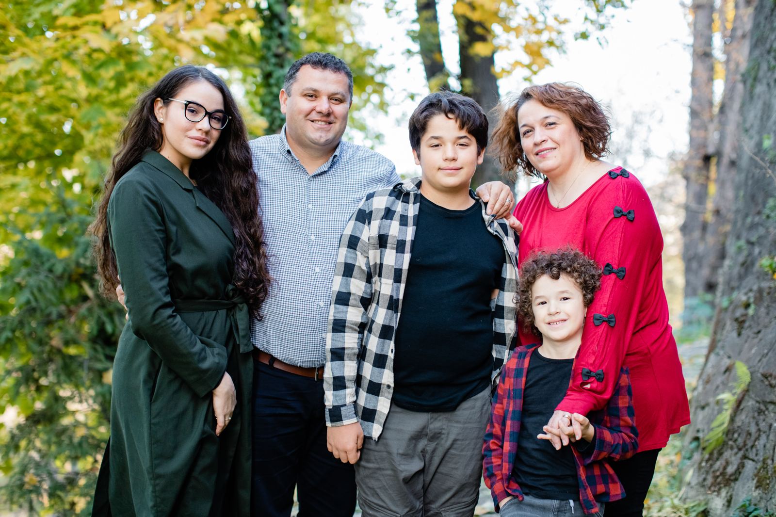 Liviu and Elena Tudosie with their three children among autumn trees